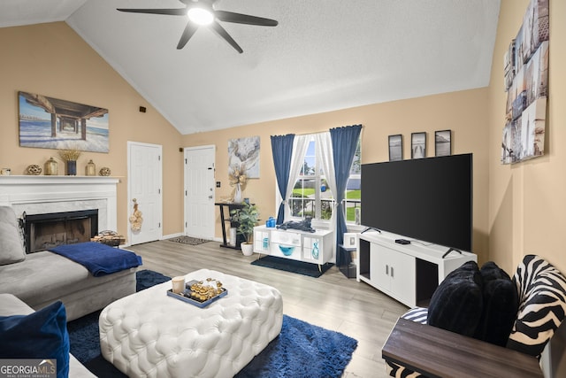 7030 Kingston Ln, Mcdonough, GA 30253 - living room featuring a ceiling fan, lofted ceiling, wood finished floors, and a fireplace