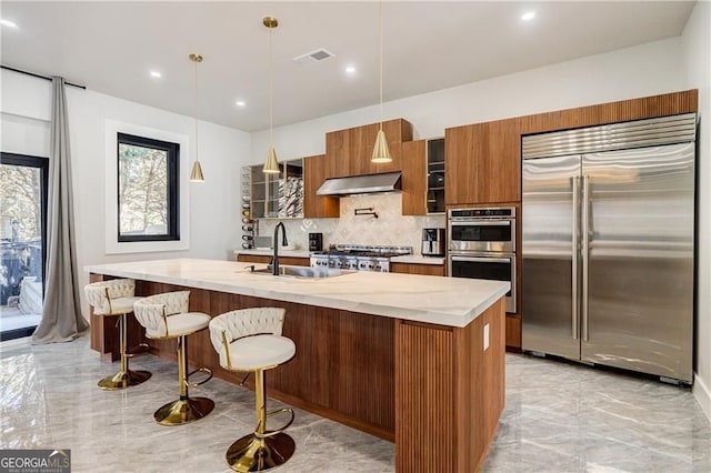 1812 Hunters Gln, Marietta, GA 30062 - kitchen featuring stainless steel appliances, extractor fan, backsplash, light marble finish floors, and brown cabinetry