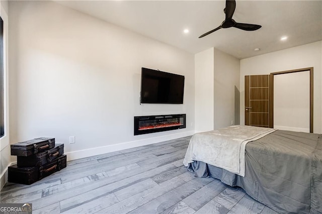 1812 Hunters Gln, Marietta, GA 30062 - bedroom with wood finished floors, recessed lighting, a glass covered fireplace, and a ceiling fan
