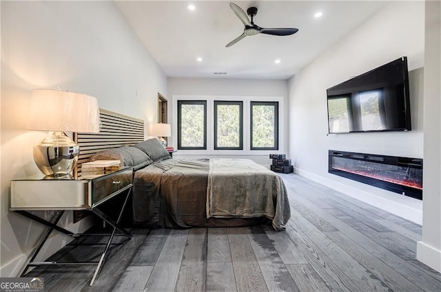 1812 Hunters Gln, Marietta, GA 30062 - bedroom featuring hardwood / wood-style flooring, recessed lighting, a glass covered fireplace, and a ceiling fan
