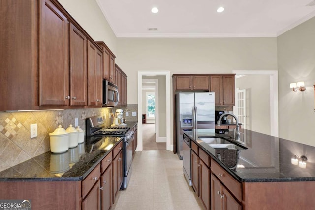 21 Creekview Dr SE, Cartersville, GA 30120 - kitchen with appliances with stainless steel finishes, tasteful backsplash, an island with sink, crown molding, and dark stone counters