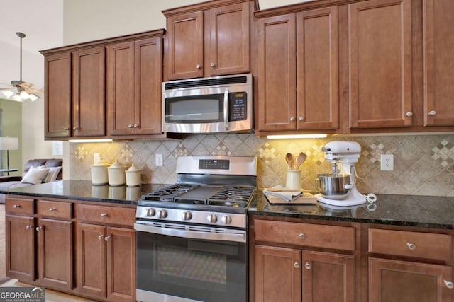 21 Creekview Dr SE, Cartersville, GA 30120 - kitchen featuring stainless steel appliances, dark stone counters, tasteful backsplash, and brown cabinets