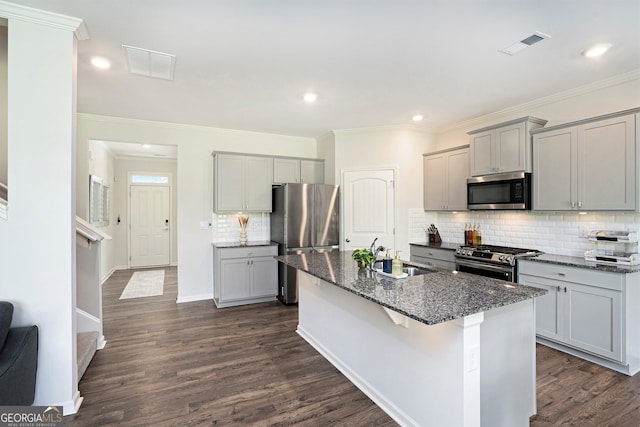7814 Messina Ct, Lithia Springs, GA 30122 - kitchen featuring stainless steel appliances, gray cabinets, dark stone counters, tasteful backsplash, and recessed lighting