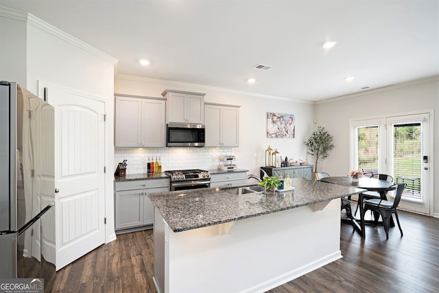 7814 Messina Ct, Lithia Springs, GA 30122 - kitchen with stainless steel appliances, gray cabinetry, dark stone counters, decorative backsplash, and crown molding