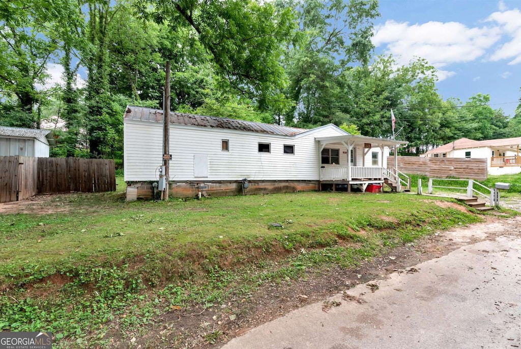 120 Hill Pl, Toccoa, GA 30577 - manufactured / mobile home featuring covered porch, a metal roof, and view of scattered trees