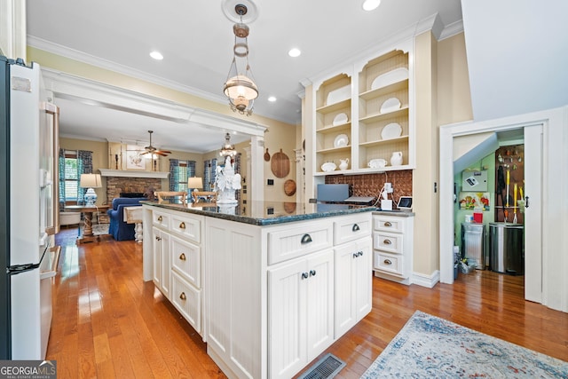 3349 Whitepath Rd, Ellijay, GA 30540 - kitchen with crown molding, open floor plan, a ceiling fan, freestanding refrigerator, and light wood-type flooring