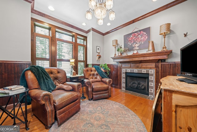 3349 Whitepath Rd, Ellijay, GA 30540 - living room featuring a wainscoted wall, light wood-style flooring, a fireplace, ornamental molding, and a chandelier
