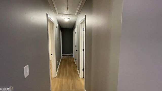 4710 Cedar Brook Dr SE, Conyers, GA 30094 - hallway with light wood-style flooring, attic access, and a textured ceiling