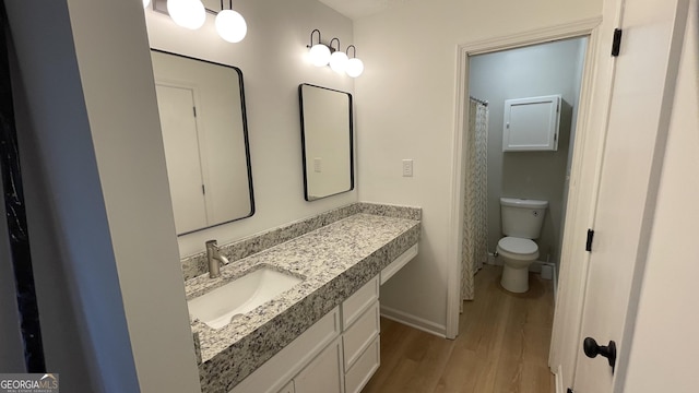 4710 Cedar Brook Dr SE, Conyers, GA 30094 - full bathroom with wood finished floors and vanity