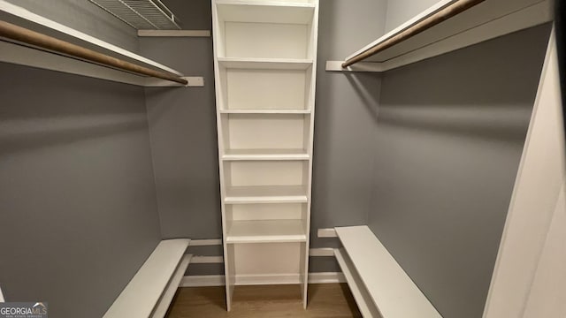 4710 Cedar Brook Dr SE, Conyers, GA 30094 - walk in closet featuring wood finished floors