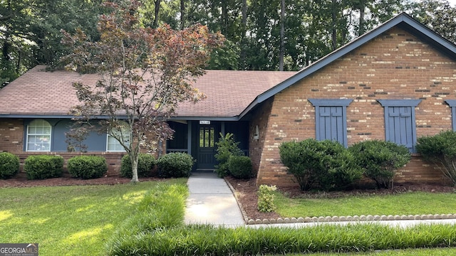4710 Cedar Brook Dr SE, Conyers, GA 30094 - view of front facade with a front lawn, brick siding, and roof with shingles
