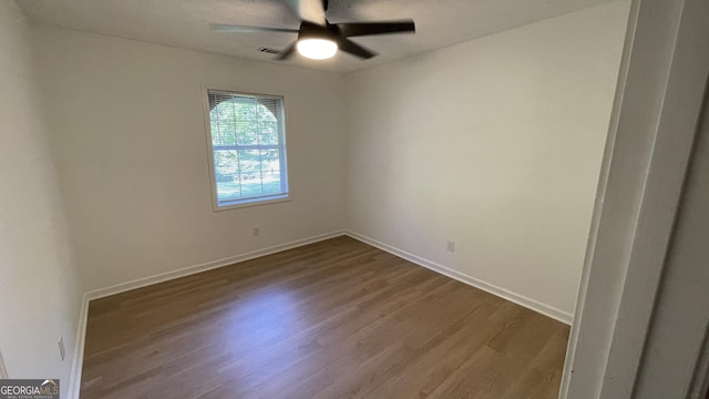 4710 Cedar Brook Dr SE, Conyers, GA 30094 - spare room with dark wood-type flooring and a ceiling fan