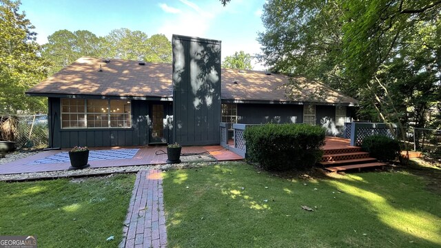 4710 Cedar Brook Dr SE, Conyers, GA 30094 - back of property with board and batten siding, a chimney, and a deck
