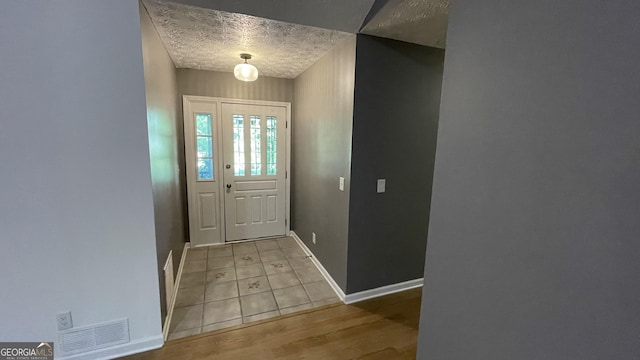 4710 Cedar Brook Dr SE, Conyers, GA 30094 - entryway featuring a textured ceiling and light wood-type flooring