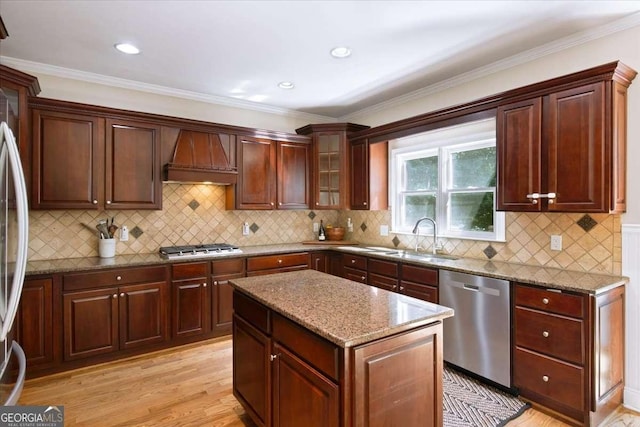 214 Davis Mill Rd, Ball Ground, GA 30107 - kitchen featuring appliances with stainless steel finishes, premium range hood, light stone counters, a kitchen island, and light wood-style flooring