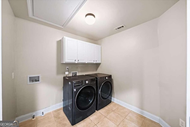 214 Davis Mill Rd, Ball Ground, GA 30107 - laundry area featuring cabinet space, light tile patterned floors, and washing machine and clothes dryer