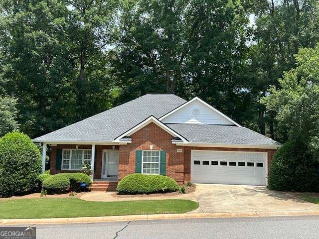 3131 Rocky Branch Rd Unit 280, Watkinsville, GA 30677 - view of front of house with a garage, concrete driveway, brick siding, roof with shingles, and a front yard