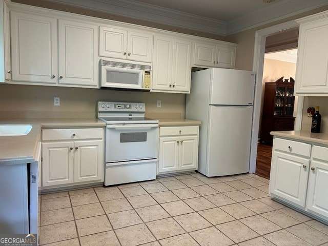 3131 Rocky Branch Rd Unit 280, Watkinsville, GA 30677 - kitchen featuring white appliances, ornamental molding, light countertops, white cabinetry, and light tile patterned flooring