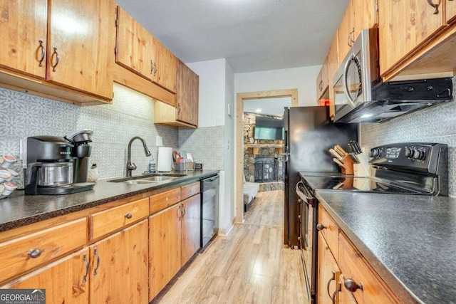 327 Brucken Strasse Unit 311, Helen, GA 30545 - kitchen with stainless steel appliances, dark countertops, light wood-type flooring, and decorative backsplash