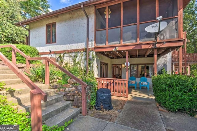 327 Brucken Strasse Unit 311, Helen, GA 30545 - view of front of property with stairway, stucco siding, and a sunroom
