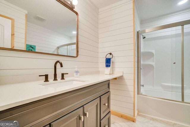 327 Brucken Strasse Unit 311, Helen, GA 30545 - bathroom with vanity, wooden walls, and shower / bath combination with glass door