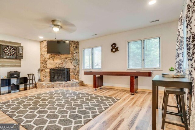 327 Brucken Strasse Unit 311, Helen, GA 30545 - living area featuring a ceiling fan, wood finished floors, and a stone fireplace
