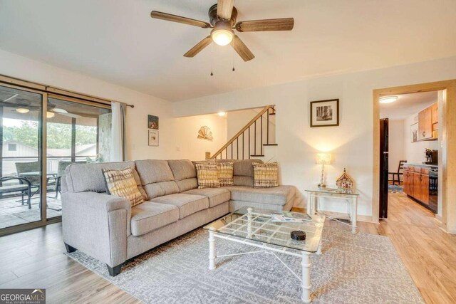 327 Brucken Strasse Unit 311, Helen, GA 30545 - living room with a ceiling fan, light wood-style floors, and stairs