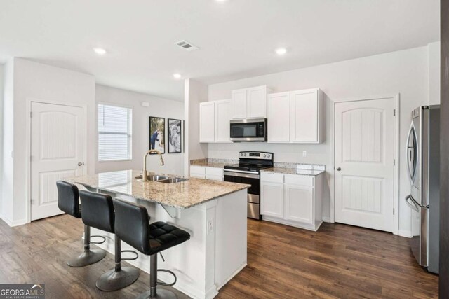 109 Grand Hickory Way, Dawsonville, GA 30534 - kitchen featuring stainless steel appliances, light stone countertops, white cabinets, dark wood-style flooring, and recessed lighting