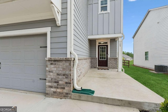 109 Grand Hickory Way, Dawsonville, GA 30534 - entrance to property featuring brick siding, board and batten siding, a garage, and a yard