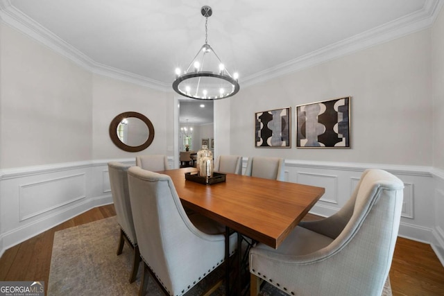 4544 Cavallon Way NW, Acworth, GA 30101 - dining space with a chandelier, dark wood-style floors, ornamental molding, wainscoting, and a decorative wall