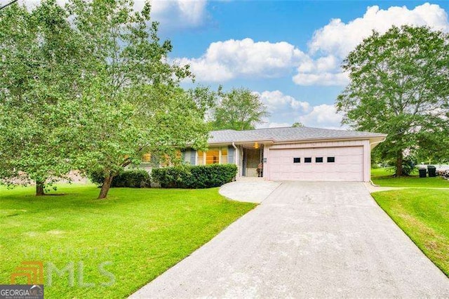 741 Greenhill Dr NE, Conyers, GA 30012 - view of front of home with an attached garage, driveway, and a front lawn