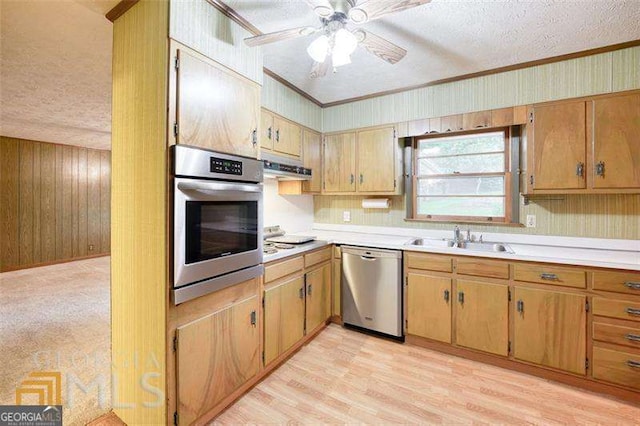 741 Greenhill Dr NE, Conyers, GA 30012 - kitchen with stainless steel appliances, a textured ceiling, crown molding, light countertops, and under cabinet range hood
