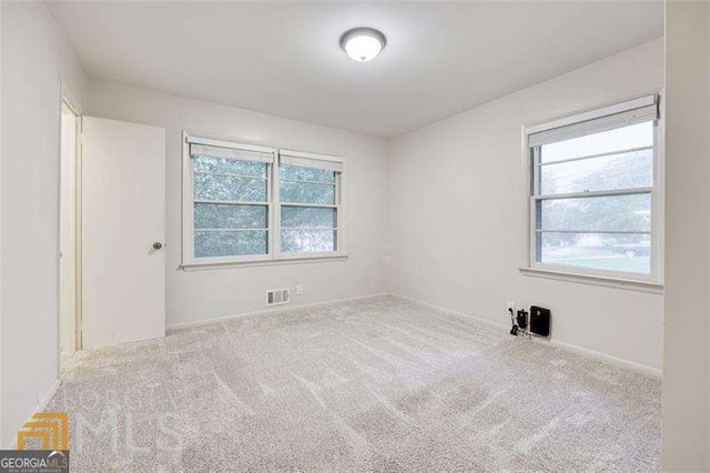 741 Greenhill Dr NE, Conyers, GA 30012 - spare room featuring plenty of natural light and carpet flooring