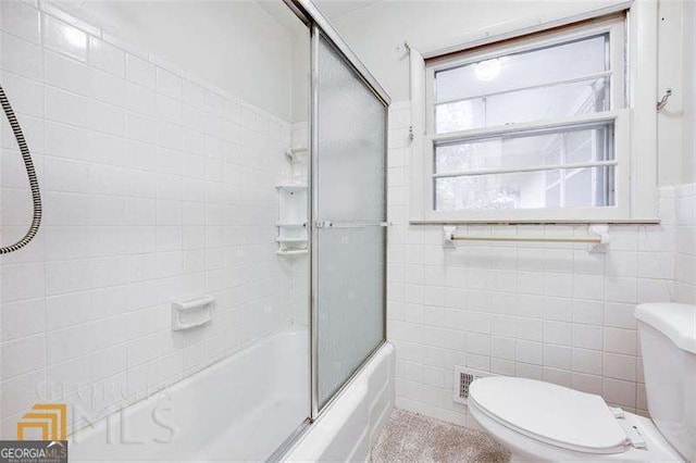 741 Greenhill Dr NE, Conyers, GA 30012 - full bath featuring tile walls and shower / bath combination with glass door