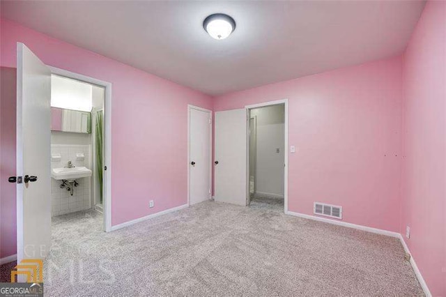 741 Greenhill Dr NE, Conyers, GA 30012 - unfurnished bedroom with carpet flooring and ensuite bathroom