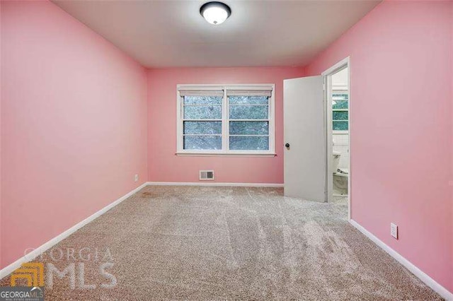 741 Greenhill Dr NE, Conyers, GA 30012 - carpeted empty room with baseboards