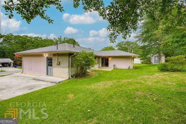 741 Greenhill Dr NE, Conyers, GA 30012 - back of house with a yard and a storage unit
