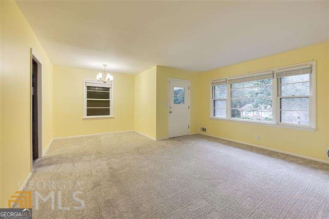 741 Greenhill Dr NE, Conyers, GA 30012 - empty room featuring a chandelier and carpet