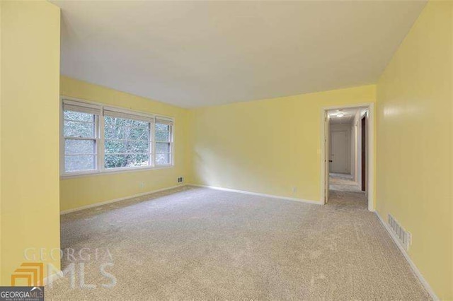 741 Greenhill Dr NE, Conyers, GA 30012 - spare room with carpet and baseboards