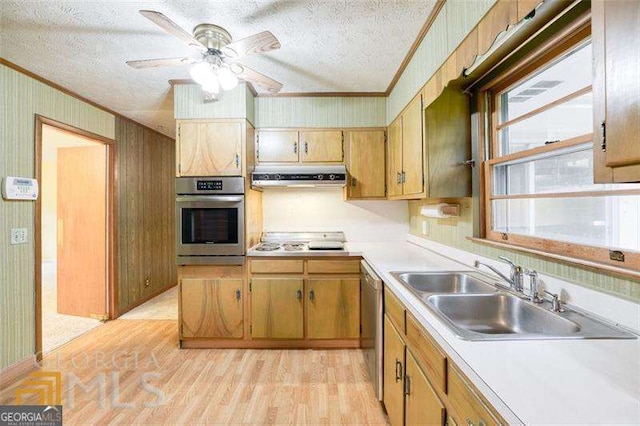 741 Greenhill Dr NE, Conyers, GA 30012 - kitchen featuring stainless steel appliances, ornamental molding, under cabinet range hood, a textured ceiling, and light countertops