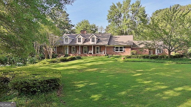 115 Shoal Creek Dr, Sharpsburg, GA 30277 - cape cod home featuring brick siding, a front yard, and a chimney
