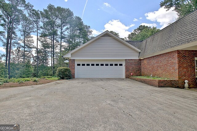 115 Shoal Creek Dr, Sharpsburg, GA 30277 - view of property exterior with brick siding and driveway