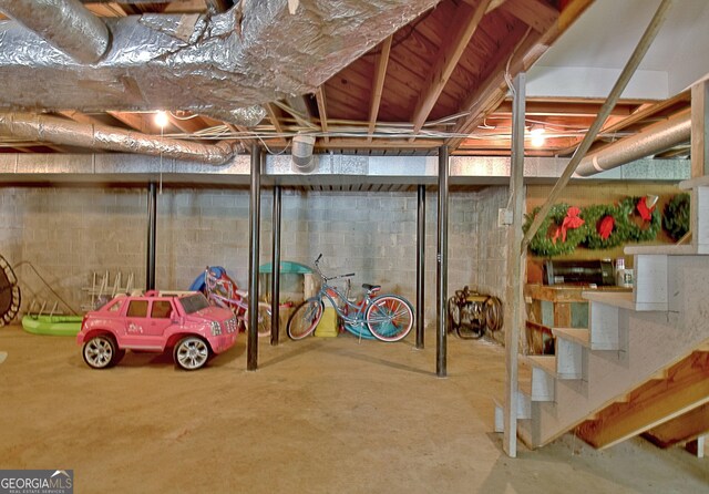115 Shoal Creek Dr, Sharpsburg, GA 30277 - unfinished basement featuring stairway and concrete block wall