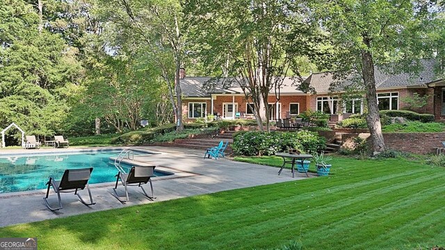 115 Shoal Creek Dr, Sharpsburg, GA 30277 - swimming pool with a patio area and a yard