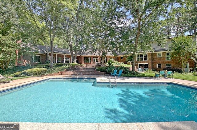 115 Shoal Creek Dr, Sharpsburg, GA 30277 - swimming pool with a patio area