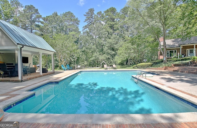 115 Shoal Creek Dr, Sharpsburg, GA 30277 - swimming pool featuring a patio area and view of wooded area