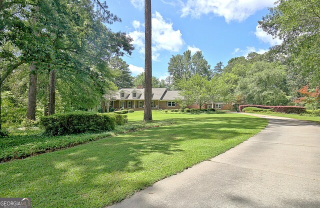 115 Shoal Creek Dr, Sharpsburg, GA 30277 - view of front of property with a front lawn and a chimney