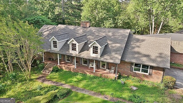 115 Shoal Creek Dr, Sharpsburg, GA 30277 - cape cod-style house with a chimney and covered porch
