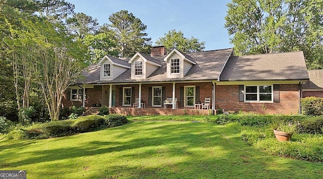 115 Shoal Creek Dr, Sharpsburg, GA 30277 - cape cod home featuring a chimney, a front yard, brick siding, and covered porch