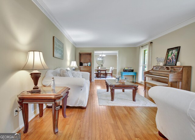 115 Shoal Creek Dr, Sharpsburg, GA 30277 - living room with light wood-style flooring, ornamental molding, and a chandelier
